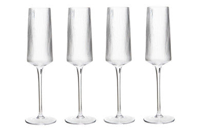 Four clear ribbed champagne glasses with tall slender stems in eldon set for elegant sparkling wine toasts