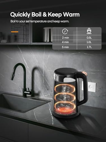 Black electric glass tea kettle with transparent body and glowing orange fast boil heating elements inside