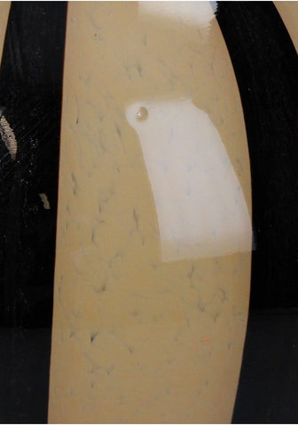 Beige curved surface with speckled texture and white patch on the back of elegant brown two toned striped vase