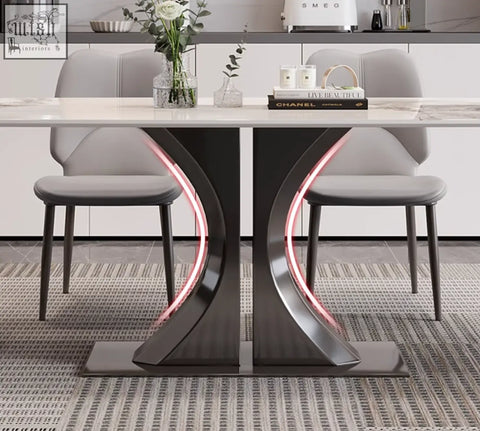 Elena dining table with white marble top and sleek black metal legs with pink led lighting perfect for any dining space and offer financing