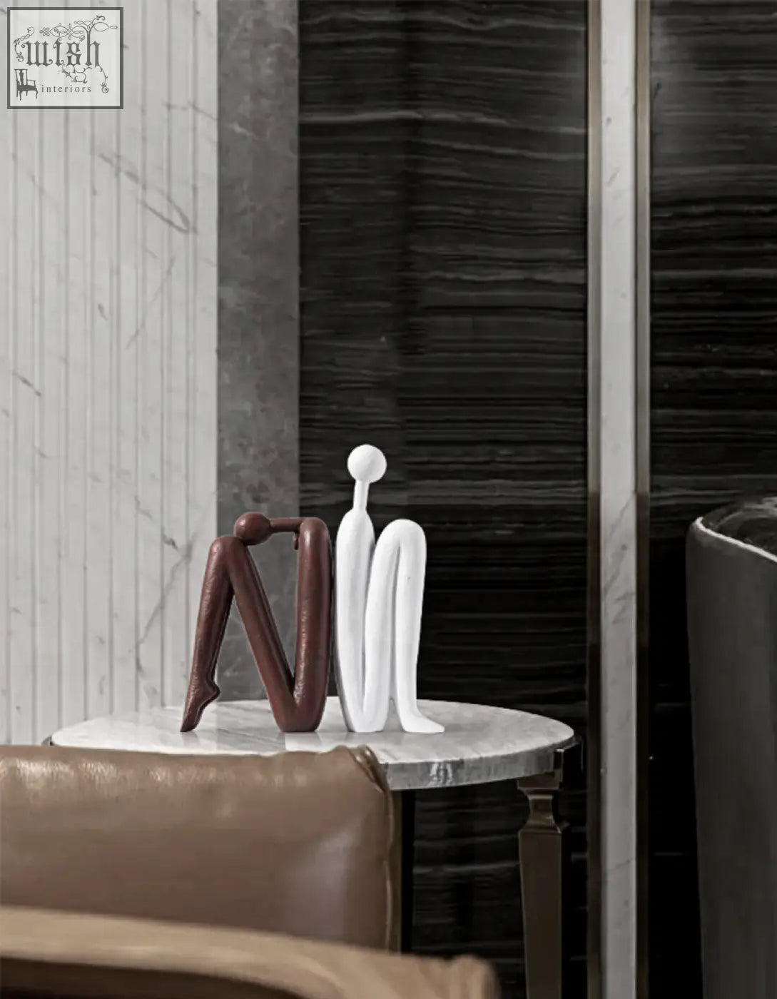 Two minimalist resin eleni bookends in matte brown and glossy white sit on a marble table for shelves decorative use