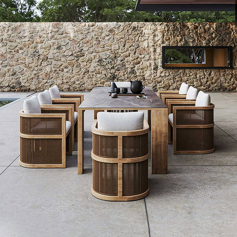 Modern eliza rttan outdoor dining set with stone top table wooden legs and gray cushioned rttan outdoor dining chairs