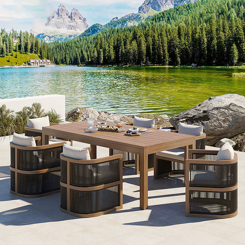 Modern eliza rttan outdoor dining table with wooden top and four dark woven mesh chairs with gray cushions