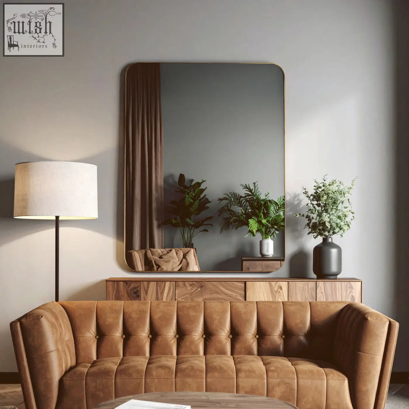 Brown tufted leather sofa with the ella gold wall mirror above featuring a stylish gold wall mirror design