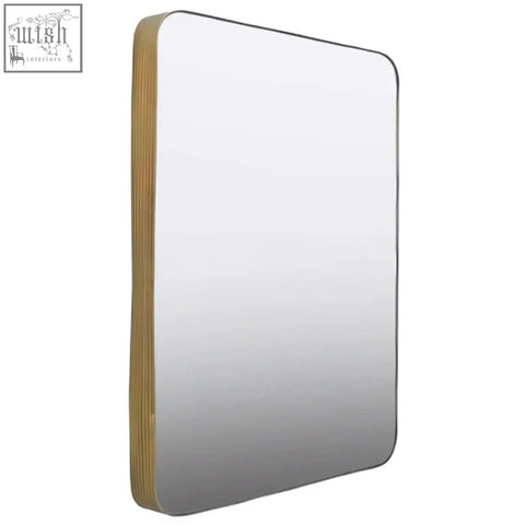 Ella gold wall mirror is a sleek rectangular wall mirror with a thin gold frame and softly rounded corners