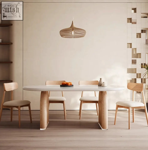 A minimalist ellison modern dining table in white sintered stone with natural wood legs and matching chairs