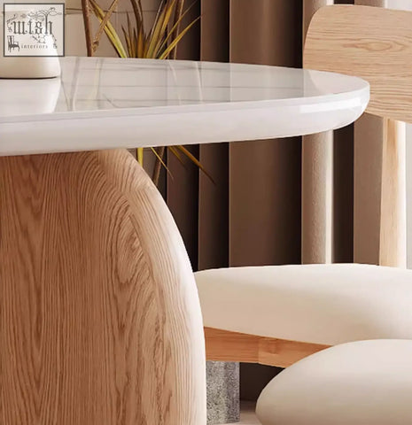 Ellison modern dining table with glossy white sintered stone top and sculpted light wood base for stylish meals