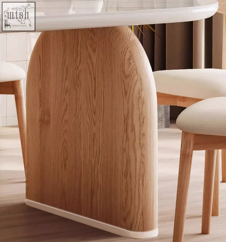 A sleek arched wooden leg with natural light brown finish on ellison modern dining table with sintered stone top