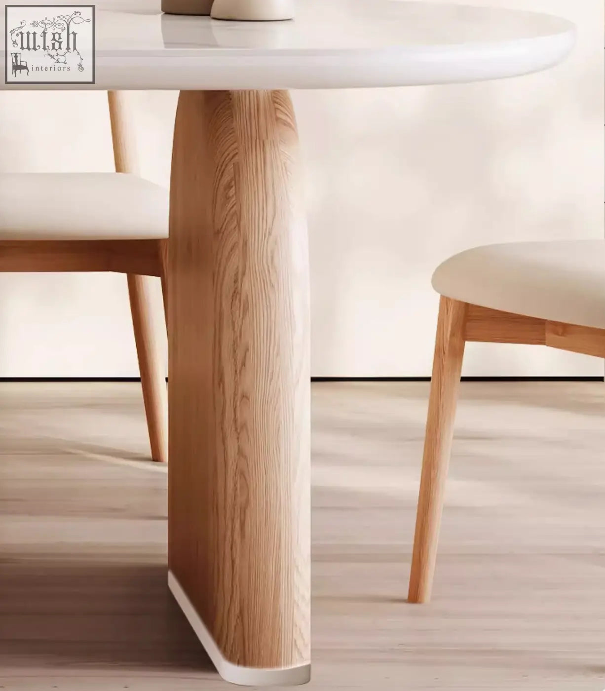 A sleek light wood leg with smooth curves and natural grain on the ellison modern dining table with sintered stone top