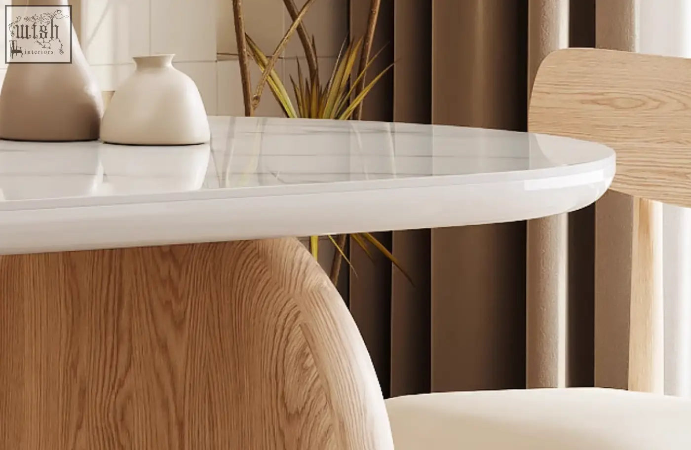 A sleek white marble top ellison modern dining table with rounded edges and a natural wood sintered stone base