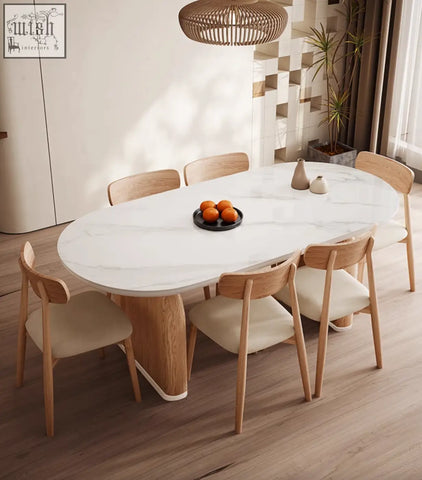 White marble oval dining table with light wood legs and matching chairs ellison modern sintered stone design