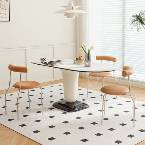 Modern elmer dining table with white oval top black sleek base and tan leather chairs for stylish dining room setup