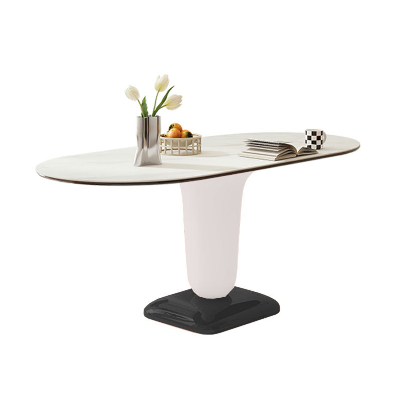 Elmer dining table with a sleek white marble oval top and a minimalist matte white to glossy black pedestal base