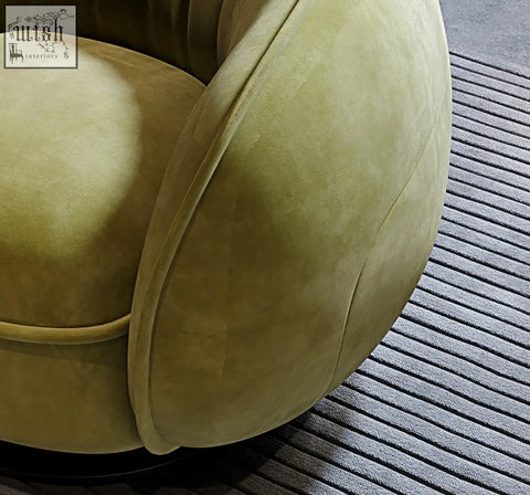 A plush olive green velvet elowen swivel lounge chair with rounded contours and modern design perfect for relaxing