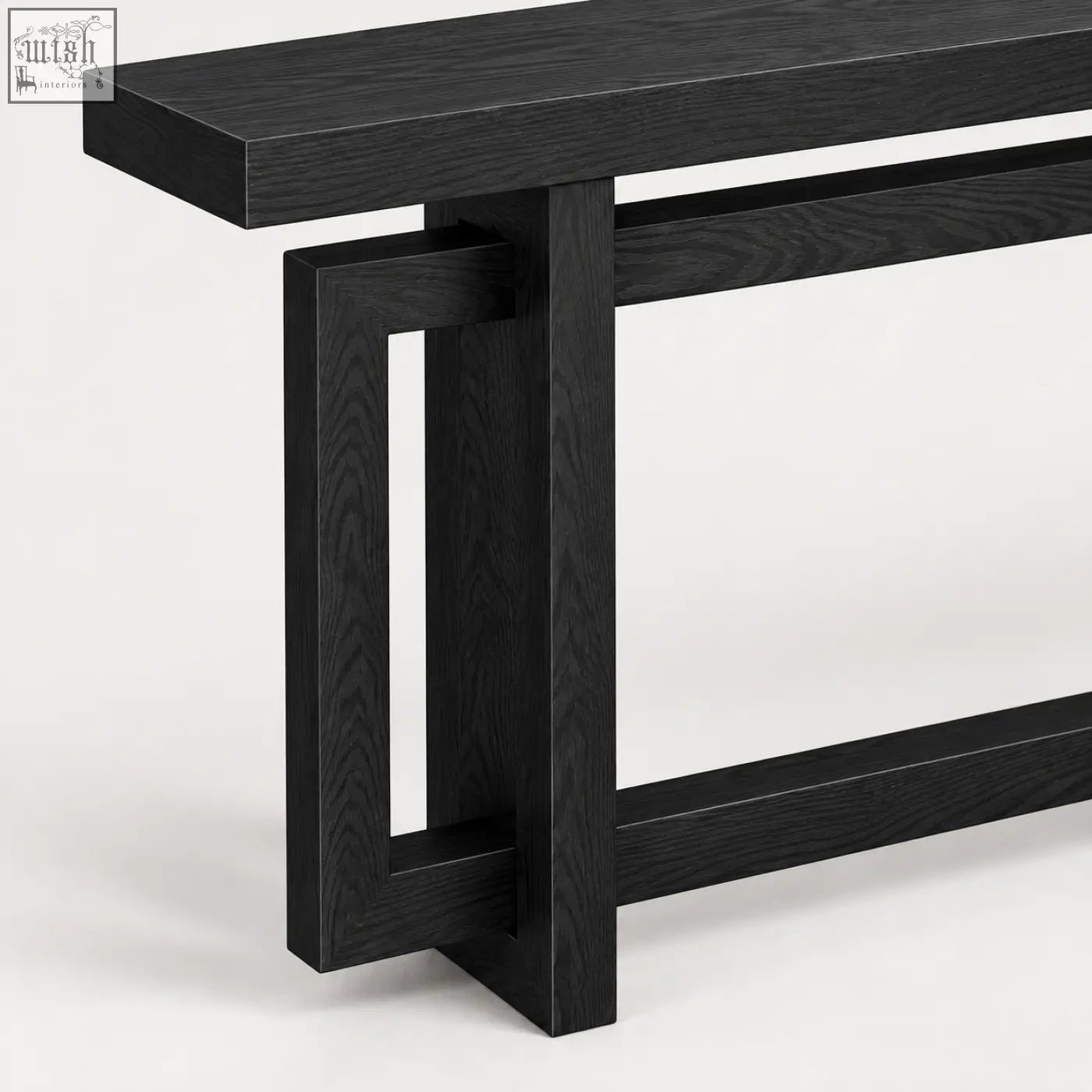 Black oak console table with sleek modern design and geometric leg structure in black wood effect finish