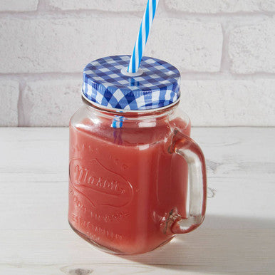 Embossed glass mason square jar mug filled with red liquid and a blue gingham lid with a checkered pattern