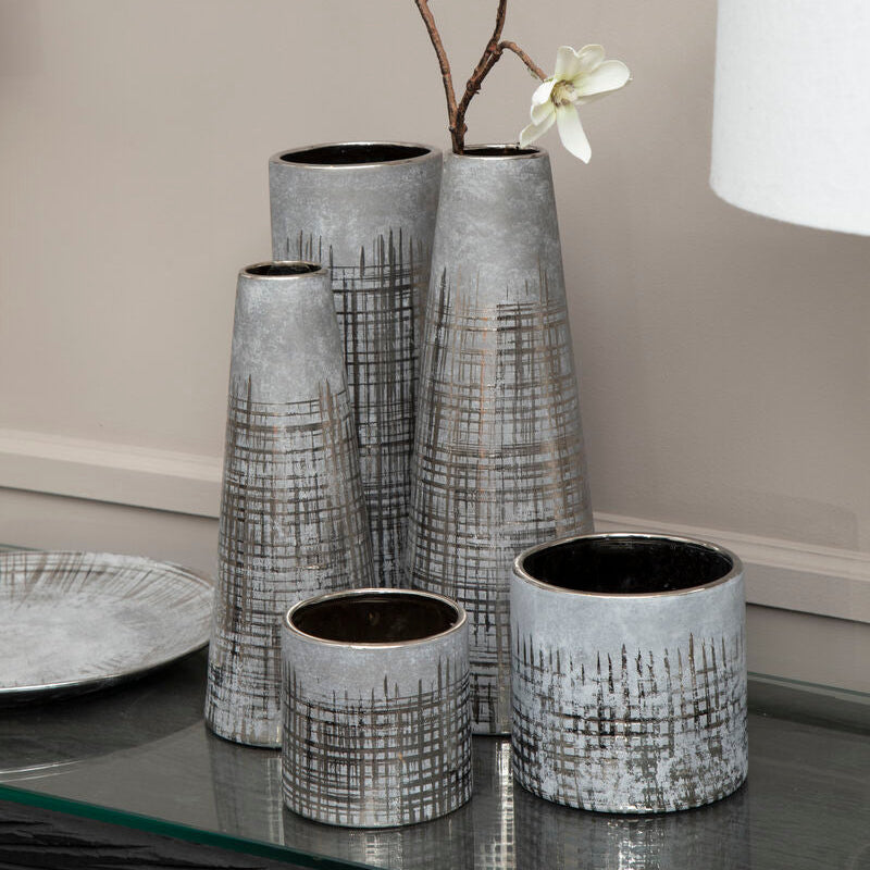 Set of five grey ceramic planters with metallic finish and black grid patterns in varying shapes and sizes
