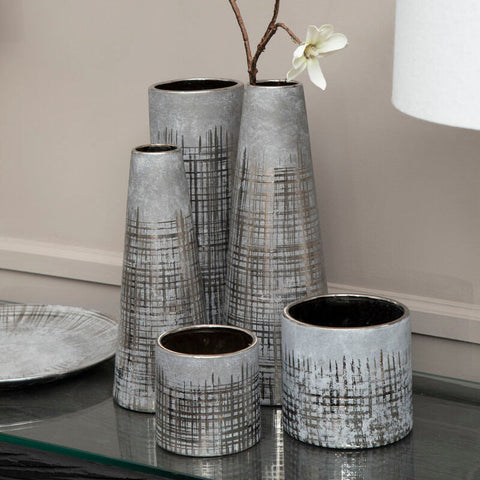 Set of five grey ceramic planters with metallic finish and black grid patterns in varying shapes and sizes