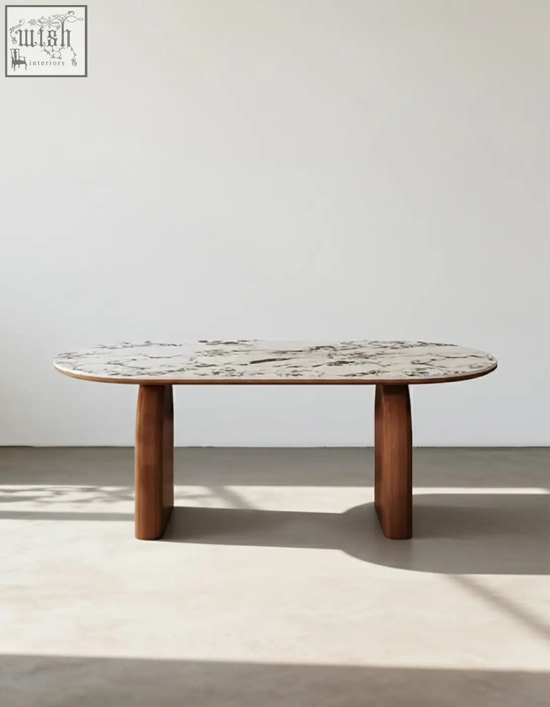 Elegant emerson dining table with an oval white and gray marble sintered stone top and dark wood legs