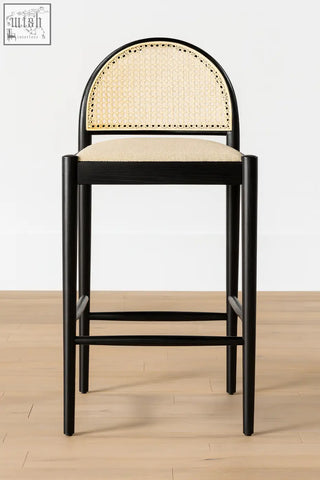 Black-framed emi bar stool with curved light beige woven cane seat and backrest perfect for home bars