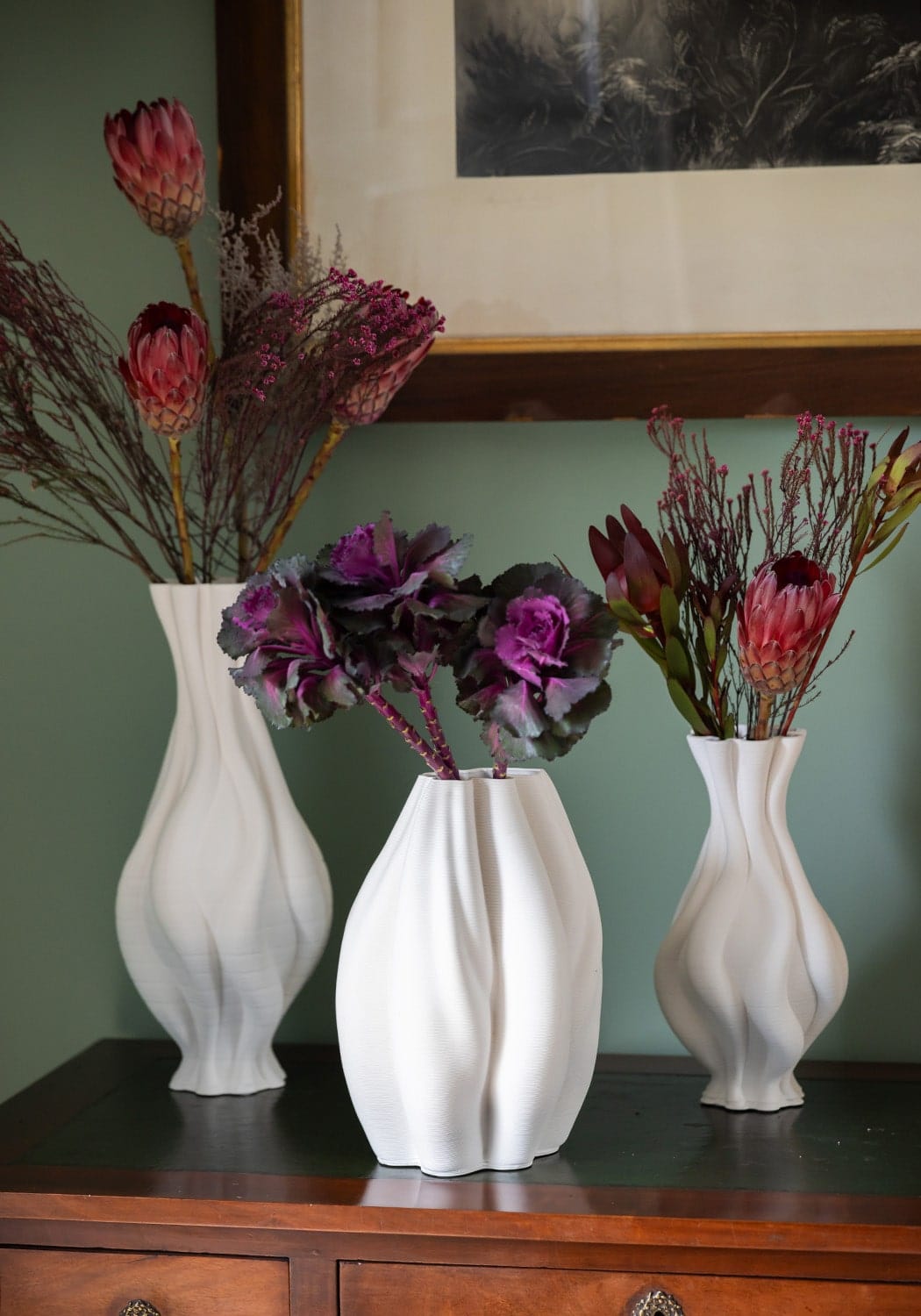 Three white ceramic vases with sculpted ribbed surfaces perfect as decorative white ceramic vase accents