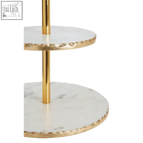 Gold finish cake stand with two white marble tiers edged in gold leaf perfect for elegant dessert display