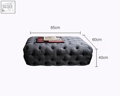 Dark gray tufted ottoman with textured fabric and button detailing for emrys chesterfield corner sofa setup