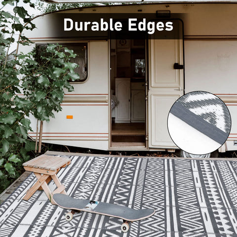 Black and white geometric patterned enyhom large grey outdoor rug with durable reinforced edges for outdoor patio use