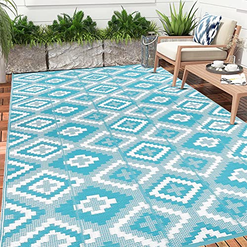 Teal and white geometric pattern enyhom large outdoor rug made of reversible plastic straw perfect for garden or patio use