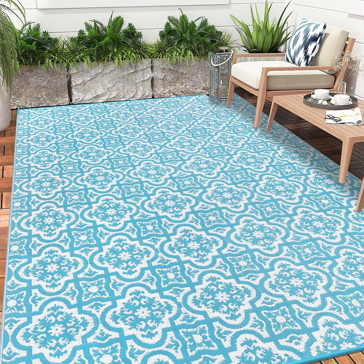 Turquoise and white patterned reversible outdoor rug made of plastic straw for garden patio and camping use