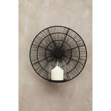 Enzo black wire wall sconce with circular design holding a white candle in clear glass wall-mounted wire wall sconce