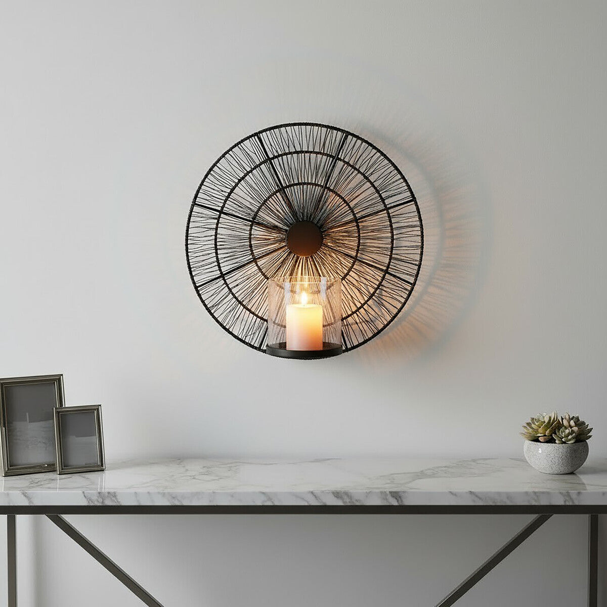 Enzo black wire wall sconce with a circular sunburst design and central glass candle holder in black wire metal