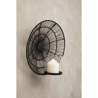 Enzo black wire wall sconce with spiral design holding a white candle in black wire wall style