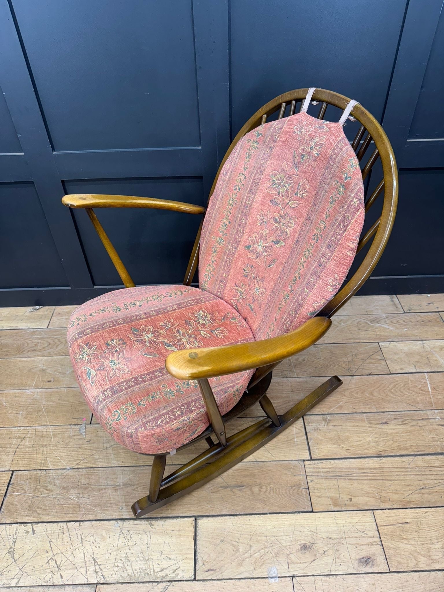 Vintage-style ercol grandfather rocking chair model 315 with pink floral upholstery and wooden curved armrests