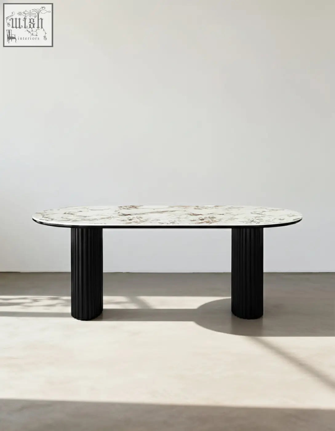 Elegant escobar dining table with oval marble top and sleek black fluted legs made of sintered stone