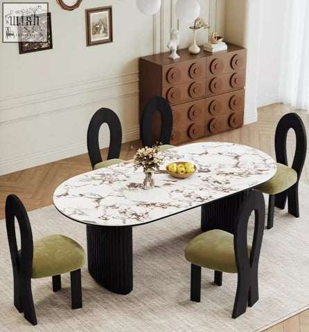 Elegant escobar dining table with white marble-patterned sintered stone top and black pedestal legs with green velvet chairs