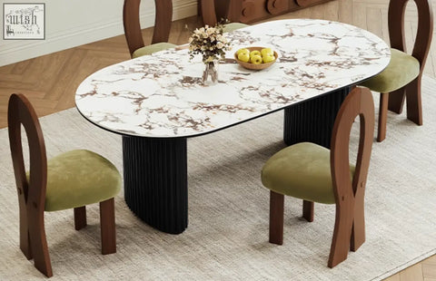 Elegant escobar dining table with white marble-patterned sintered stone top and black ribbed legs with green velvet chairs