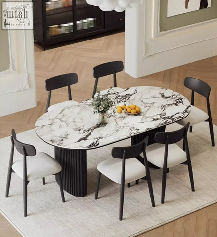 Elegant escobar dining table with oval white marble top and ribbed black legs perfect as a stylish dining table