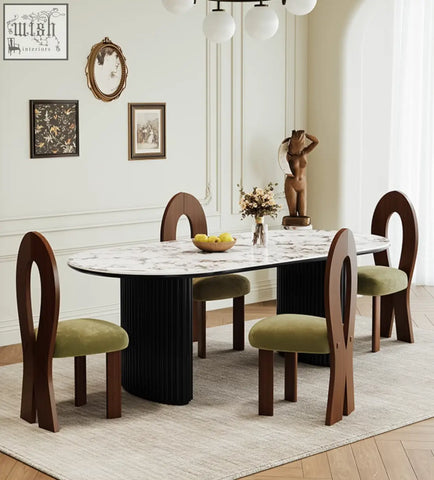 Marble-top escobar dining table with black ribbed pedestal base and four wooden chairs with olive green seats