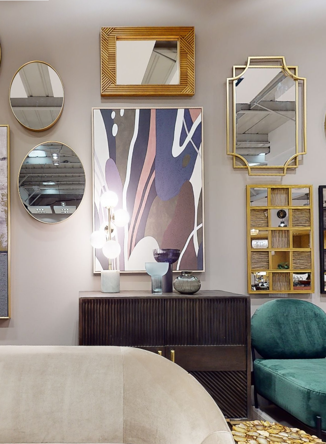 Gold-framed rectangular mirror with textured woven design reflecting esma small light blue glass vase