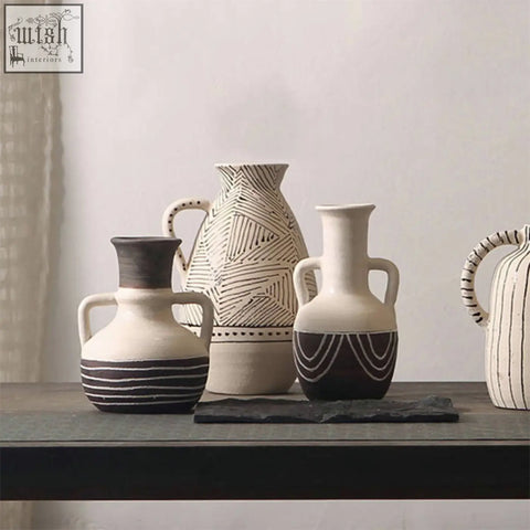 A collection of esme ceramic vases in earthy tones with geometric patterns and contrasting black accents ceramic vase