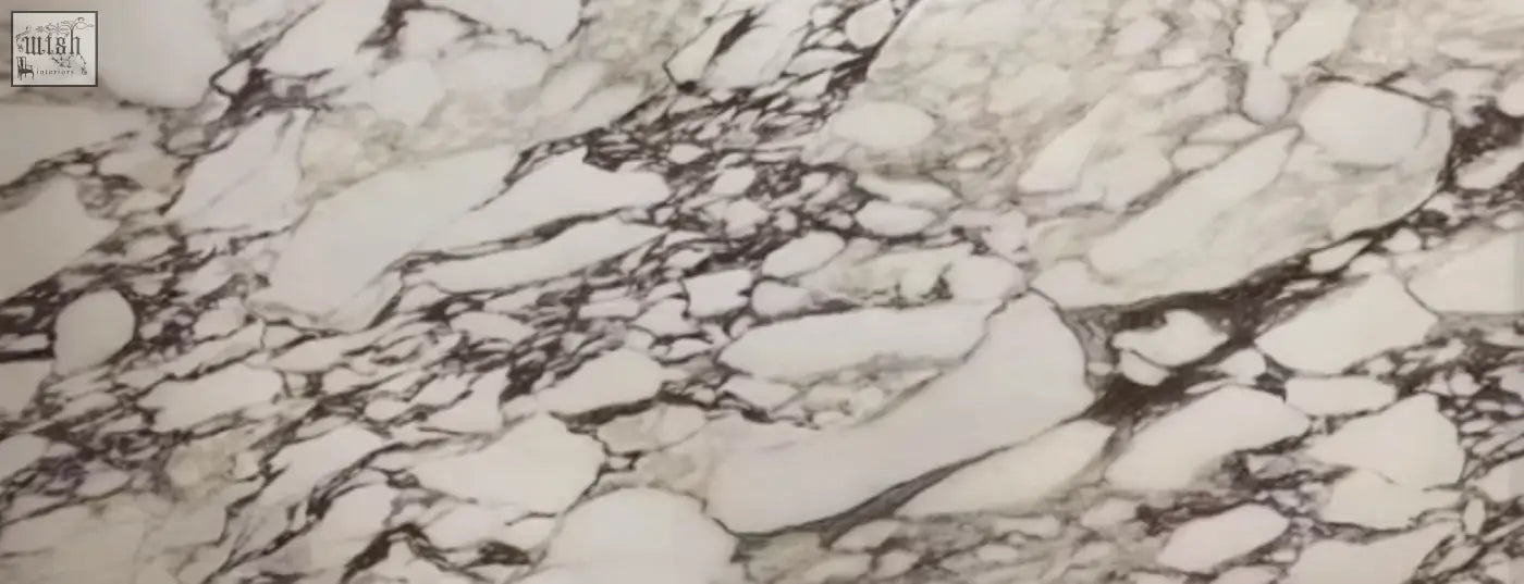 Esther oval dining table with black and white marble sintered stone countertop featuring natural swirling veins