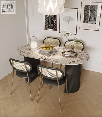 Marble-veined esther oval dining table with sleek black cylindrical legs in sintered stone for modern dining