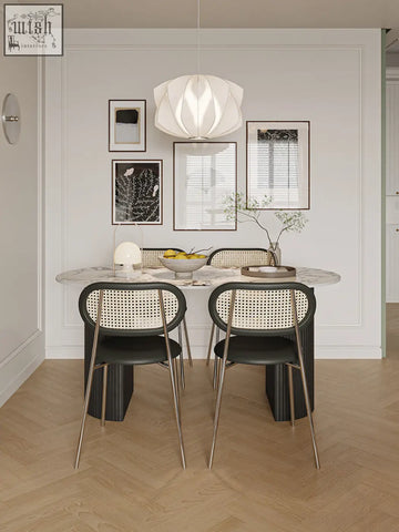 Modern black and beige cane-backed dining chairs with sleek metal legs paired with esther oval dining table
