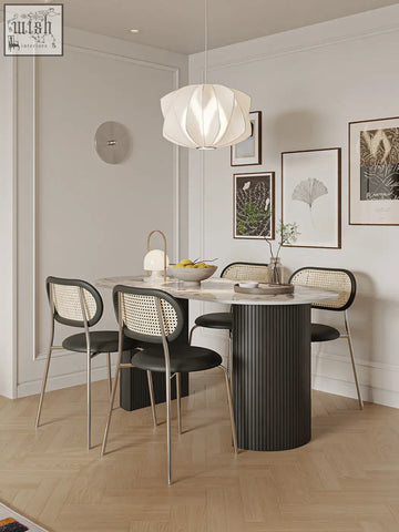 Modern black columnar esther oval dining table with marble top and sleek metallic legs perfect as an oval dining table