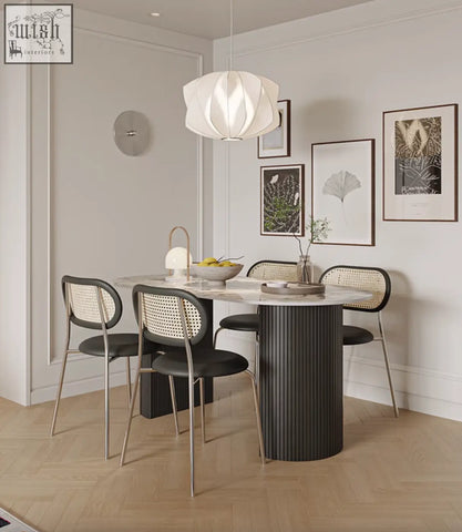 Modern black esther oval dining table with a marble sintered stone top and vertical ribbed texture