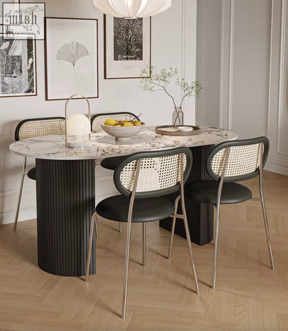 Modern esther oval dining table with a white marble top and black ribbed pedestal base perfect for dining rooms