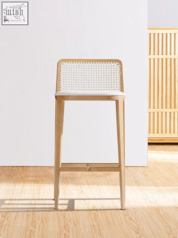Light wood ethan rattan barstool with woven cane back and white seat perfect next to a coffee table set