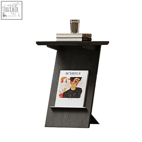 Black solid wood eunice side table with sleek angular design and integrated magazine rack for easy storage