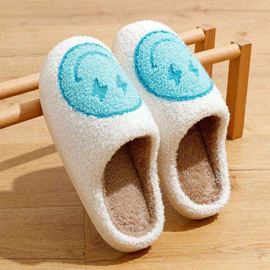 White fuzzy euphoria slippers with light blue smiley face embroidery perfect to stay warm and cozy